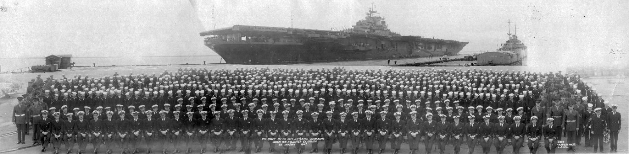 Oversize panoramic of the officers and crew of USS Boxer (CV-21) posing on a pier with their ship in the background, January 25, 1947. At this time CPT R.N. Hunter was the commanding officer, with CDR W.W. Hollister serving as Executive Officer.