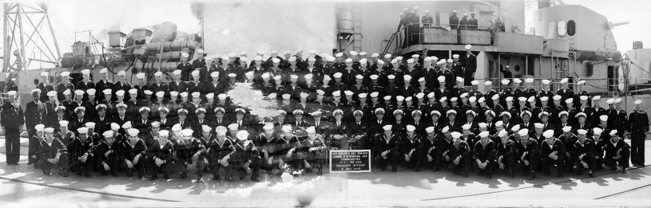 Officers and crew of USS Myles C. Fox (DD-829) posing on and alongside their ship, July 8, 1948. CDR H.G. Munson (directly above the sign) was commanding officer, with LT E.L. Fox serving as Executive Officer.