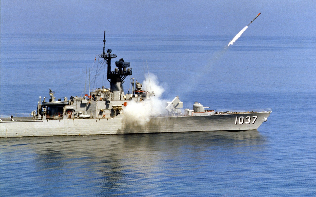 Two images of USS Bronstein (FF-1037) firing ASROC rocket, circa 1980s. One of the images is heavily scratched. 