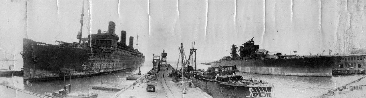 Waterfront view of Newport News Shipbuilding & Drydock Co., VA, ca. 1920. USS Maryland (BB-46) is fitting out at right, ex-USS Leviathan (SP-1326) is in for refit at left, and a yacht is fitting out in the center.