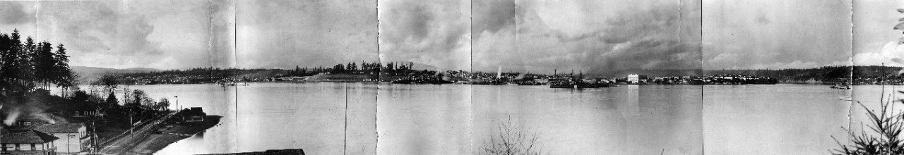 Oversize panoramic of the view of Puget Sound Navy Yard, Bremerton, WA, ca. 1919-21. Photographed from the opposite shore; several battleships and cruisers are present.