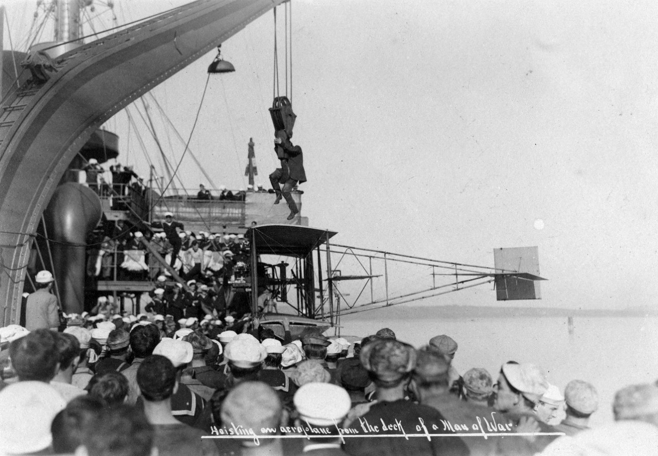Hoisting an aeroplane from the deck of a Man of War