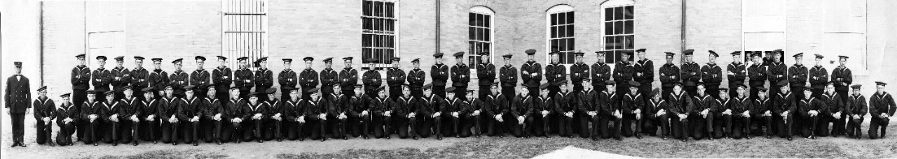 Recruit trainees and Chief Petty Officer at Naval Training Station Newport, RI, ca. 1916-1920. Some of the men's hat bands are labeled USS Constellation.