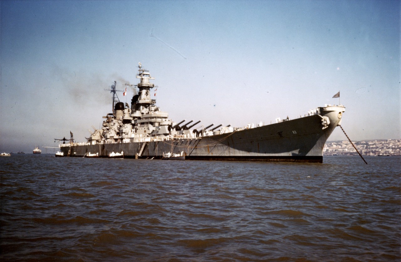 Original caption indicates that this photo shows USS Missouri (BB-63) anchored off Piraeus, Greece, April 1946. Closer inspection of ship configuration, as well as comparison to photo 80-G-366527 taken off Greece in April 1946, seems to indicate that this photo was taken at a later date.