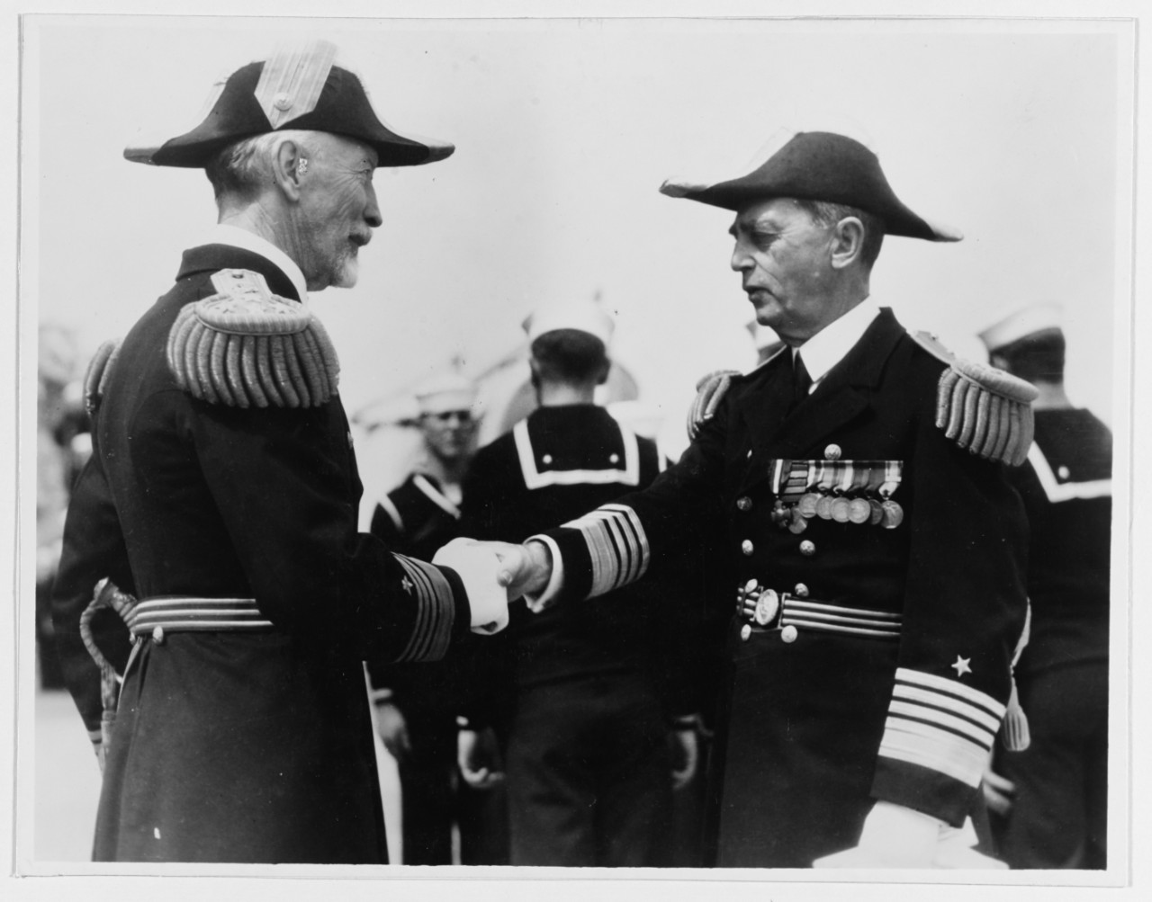 Photo #: NH 47298  Admiral William D. Leahy (right) shakes hands with Admiral Joseph M. Reeves