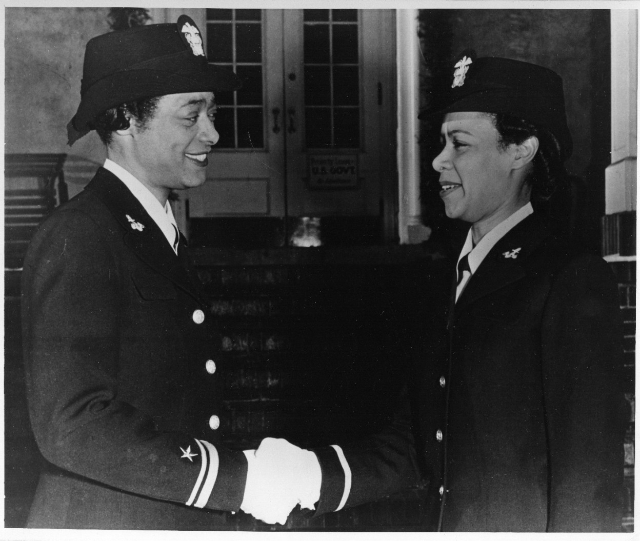 Lieutenant (Junior Grade) Harriet Ida Pickens (left), and Ensign Frances Wills congratulate each other after being being commissioned as the first African-American WAVES officers, December 1944. They were members of the final graduating class of the Naval Reserve Midshipmen's School (WR) at Northampton, Massachusetts. U.S. Naval History and Heritage Command Photograph.