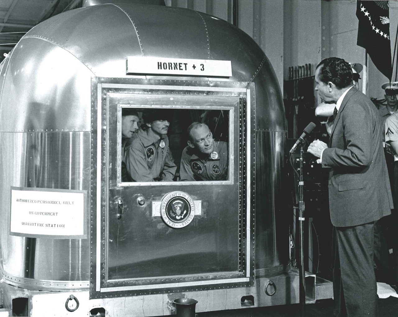 <p>President Richard M. Nixon speaks with the Apollo 11 astronauts inside the Mobile Quarantine Facility.&nbsp;</p>
