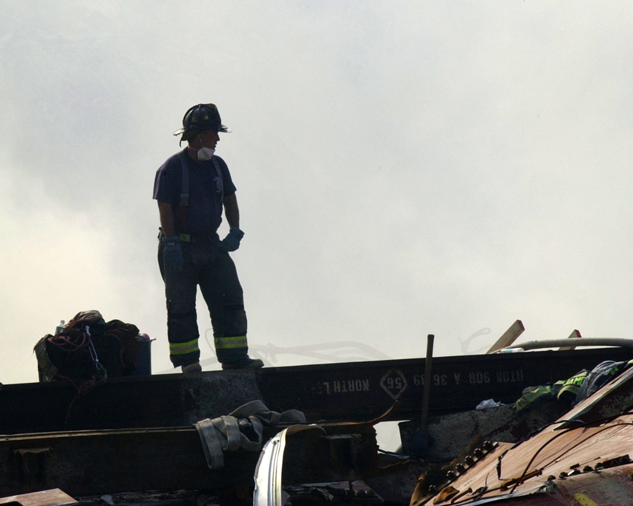 A New York City firefighter stands in the wreckage of the World Trade Center on 15 September 2001
