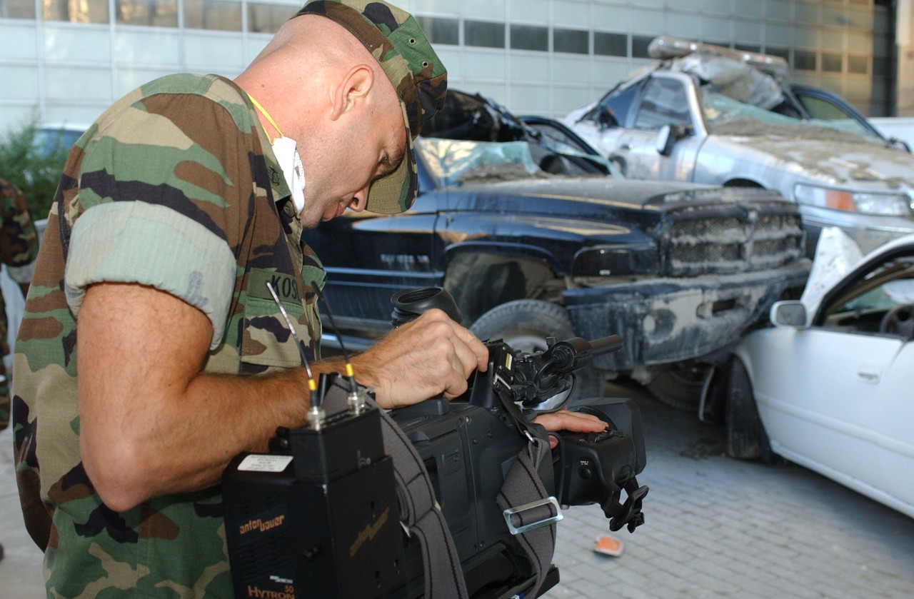 A Navy combat photographer documents the scene near Ground Zero following the attacks on 9/11, 15 September 2001