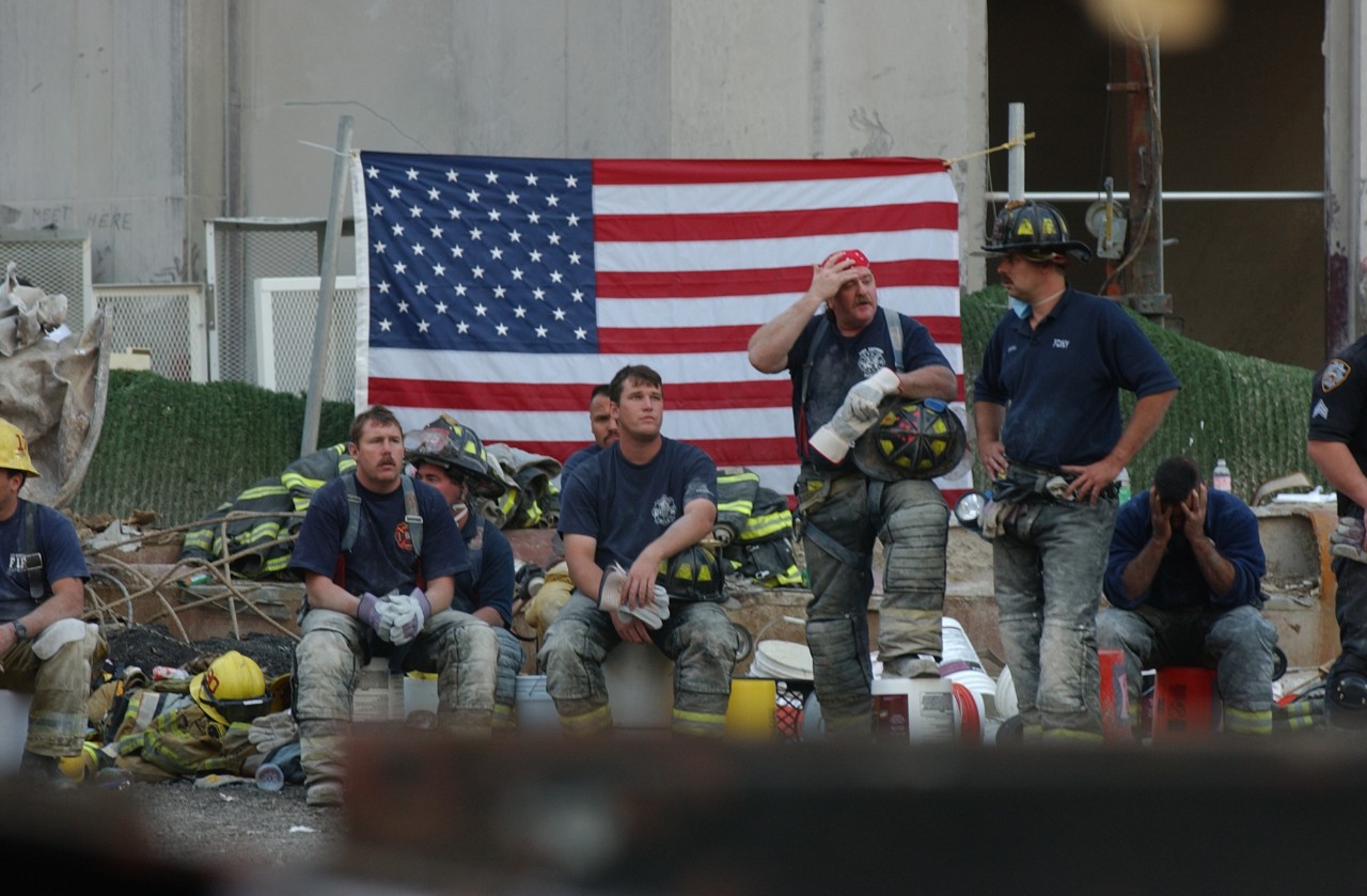New York City police and fire personnel take a break after working at Ground Zero in New York City following the attacks on 9/11, 16 September 2001