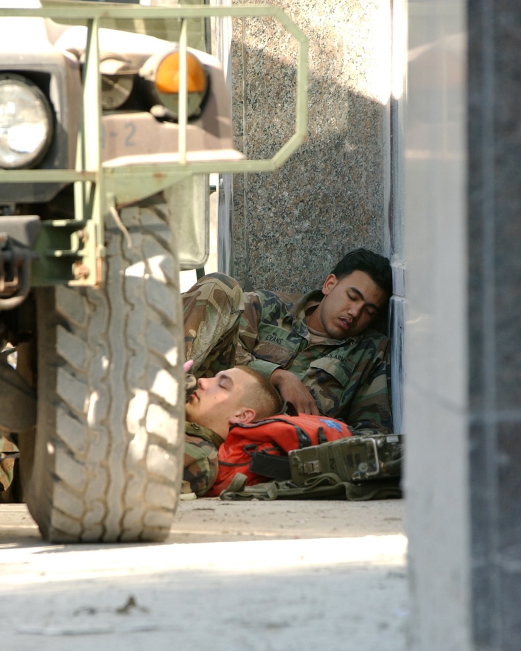 Two Army Reserve Soldiers catch some rest between shifts of guarding the perimeter around the ruins of the World Trade Center, 16 September 2001