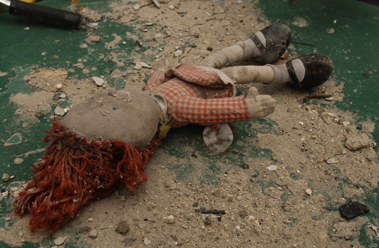 A child's doll lay on the floor of an apartment in one of the buildings that was damaged by the collapse of the nearby World Trade Center, 16 September 2001