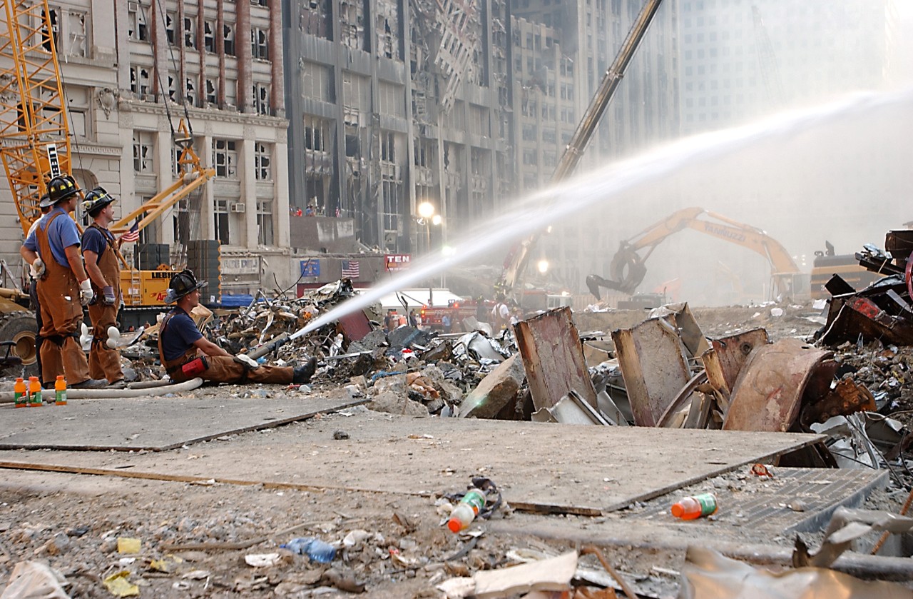Firefighters still work to extinguish the smoldering debris at Ground Zero more than a week after the attacks on 9/11, 19 September 2001