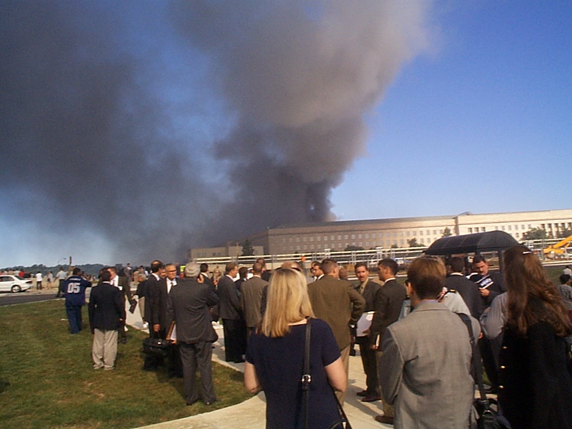 Pentagon employees along with members of the Crane Group gather in the South Parking Lot area following the attack, 11 September 2001