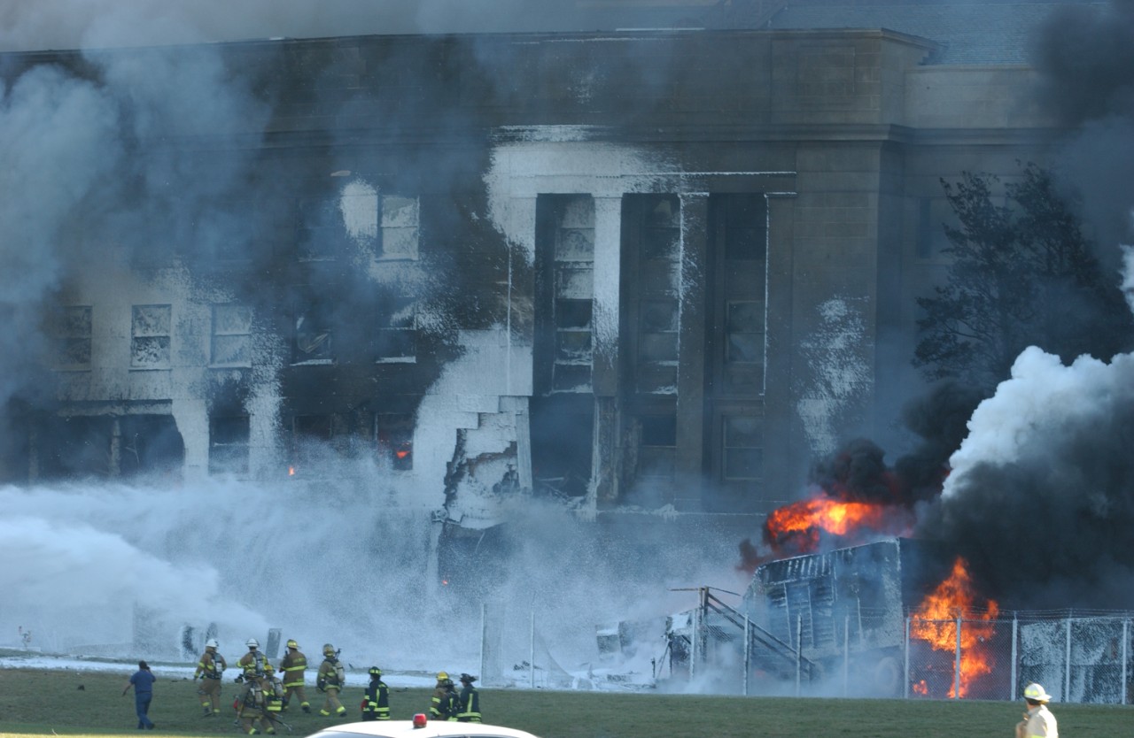 Fire crews work to put out the flames minutes after the attack, 11 September 2001