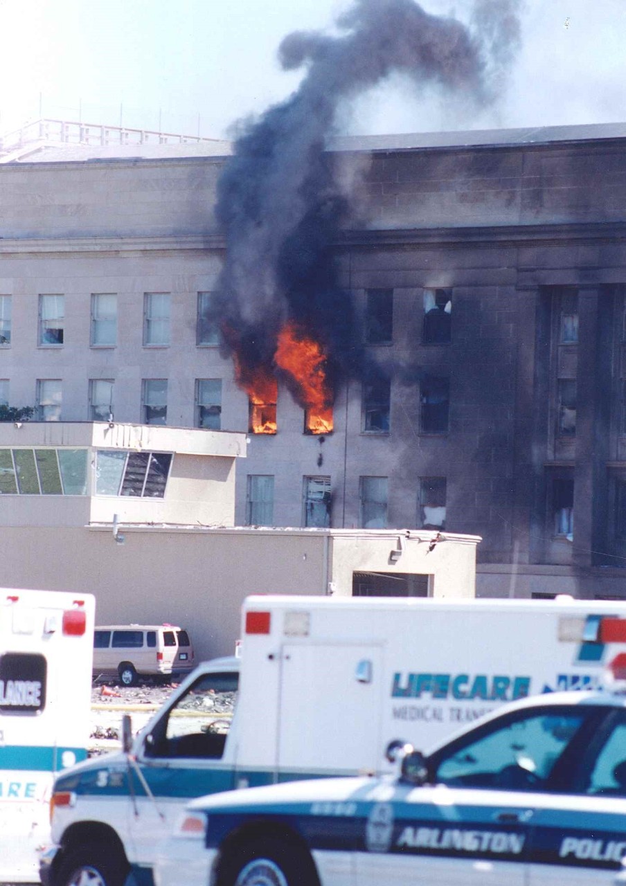 Flames escape from E Ring office windows near the heliport control tower, 11 September 2001