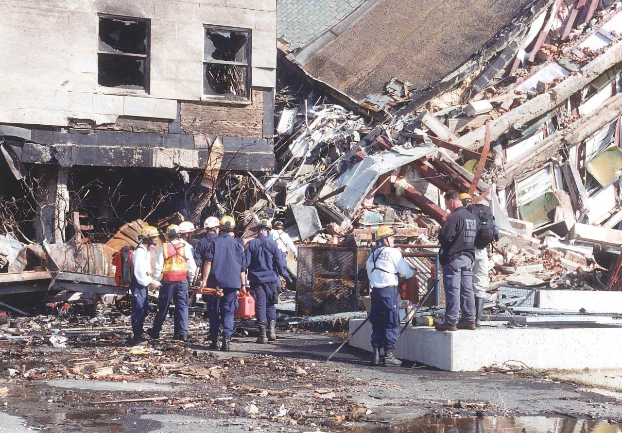 FBI personnel and emergency response teams work near the collapsed E Ring, 11 September 2001