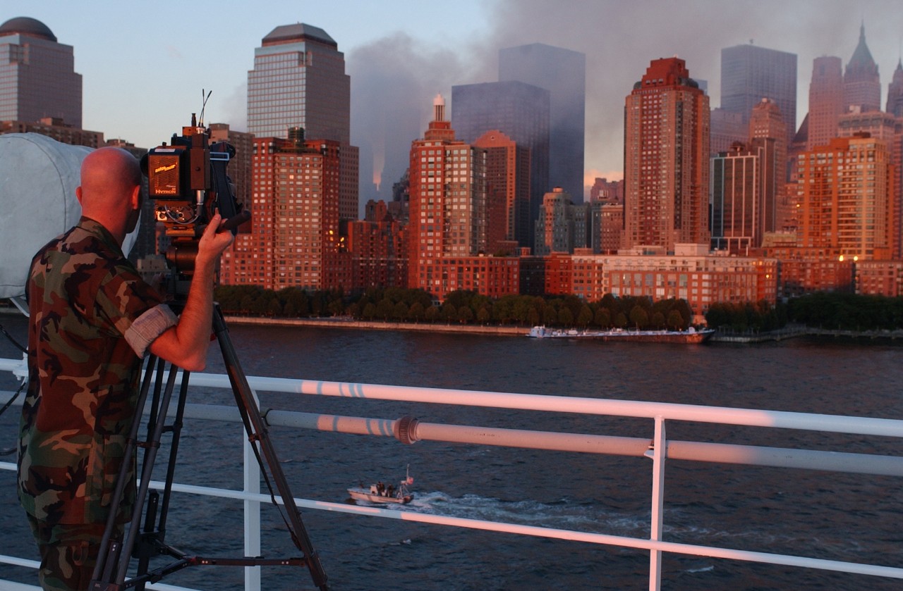 A combat photographer records the scene as USNS COMFORT (T-AH 20) sails past Lower Manhattan on 14 September 2001