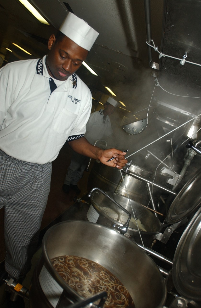 A Petty Officer aboard USNS COMFORT (T-AH 20) prepares french onion soup to feed to police officers, firefighters, and volunteers who are working at Ground Zero in New York City, 19 September 2001