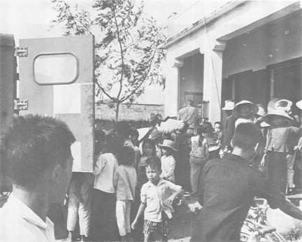 Image of Vietnamese Gather around Temporary Dispensary at An Hai for Medical Treatment