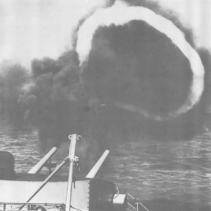 Image of A "ring of fire" is momentarily formed by the guns of a destroyer taking aim at VC positions in South Vietnam