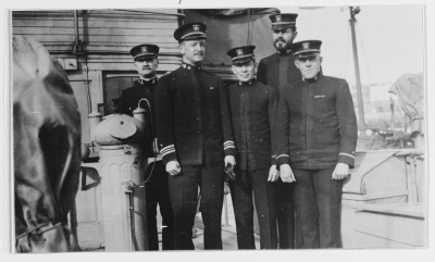 Ship's officers stand by her binnacle, while USS Margaret was at Ponta Delgada, Azores, circa December 1917. Lieutenant Commander Frank Jack Fletcher, her Commanding Officer, is just left of center. Photographed by Raymond D. Borden (NH 46584)