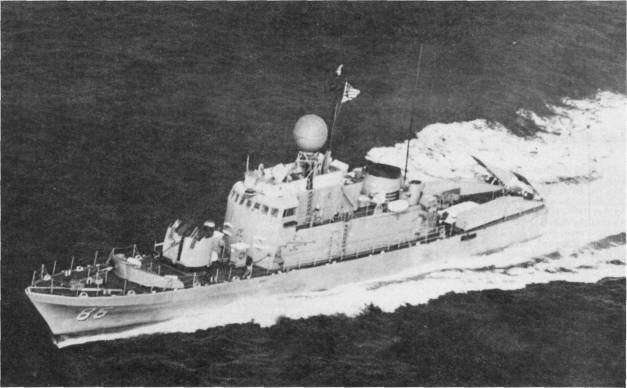 Black and white image of ship traveling from right to left, showing a wide, white wake