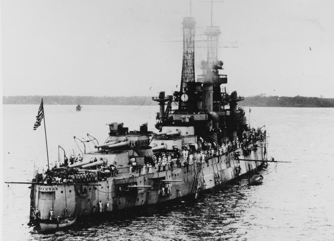 A stern view of the ship shows her weathered following service in World War I, but despite the stack smoke her distinctive cage masts rise prominently, 1920. (Naval History and Heritage Command Photograph NH 72924)