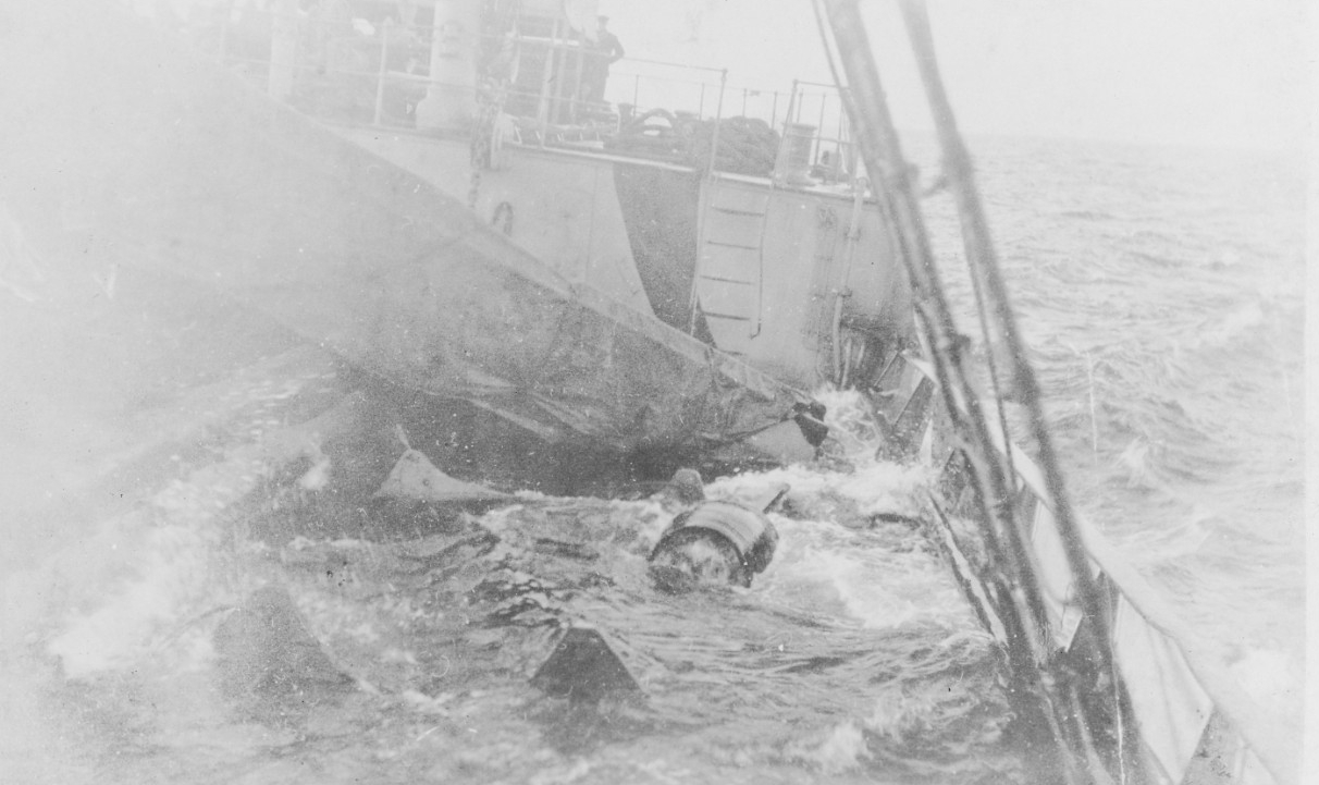 Santee’s after well deck awash, while being towed into Queenstown after receiving torpedo damage. Note the wrecked motor launch and debris on the water-washed deck. (Courtesy of Capt. David C. Hanrahan, November 1929, Naval History and Heritage C...