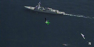 A ScanEagle unmanned aircraft system films Bainbridge as she confronts the pirates who hold Capt. Richard Phillips, the master of U.S.-flagged container ship Maersk Alabama, hostage in a lifeboat in the Indian Ocean, 9 April 2009. (Unattributed U.S. Navy Photograph 090409-N-0000X-136, Defense Visual Information Center)
