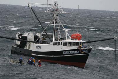 Sailors from Bainbridge render assistance to Abracadabra after the fishing vessel loses power east of Delaware Bay, 9 November 2010. Bainbridge steams 90 nautical miles through rough seas to reach Abracadabra, and then tows her to safety. (Chief Intelligence Specialist Deshonia Weslgy, U.S. Department of Defense Photograph 338895, Defense Visual Information Center)