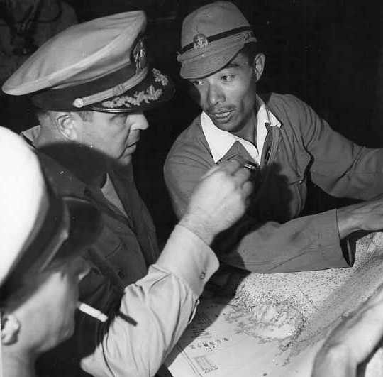 Commander and a Lt. discuss route with map in hand