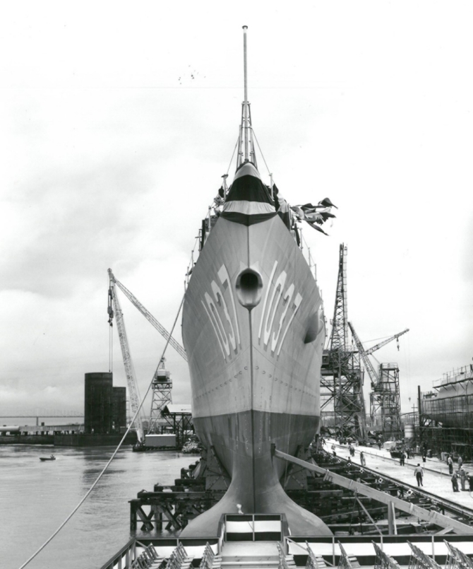 A forward view of Bronstein (DE-1037) shows her sharp “clipper bow” and the large AN/SQS-26 sonar dome, while on the launching ways at Avondale Shipyards, Inc., Westwego, La., 31 March 1962. (Unattributed Avondale Photograph 11590, donated to the Navy, Bronstein (FF-1037), Ships History File, Naval History and Heritage Command)