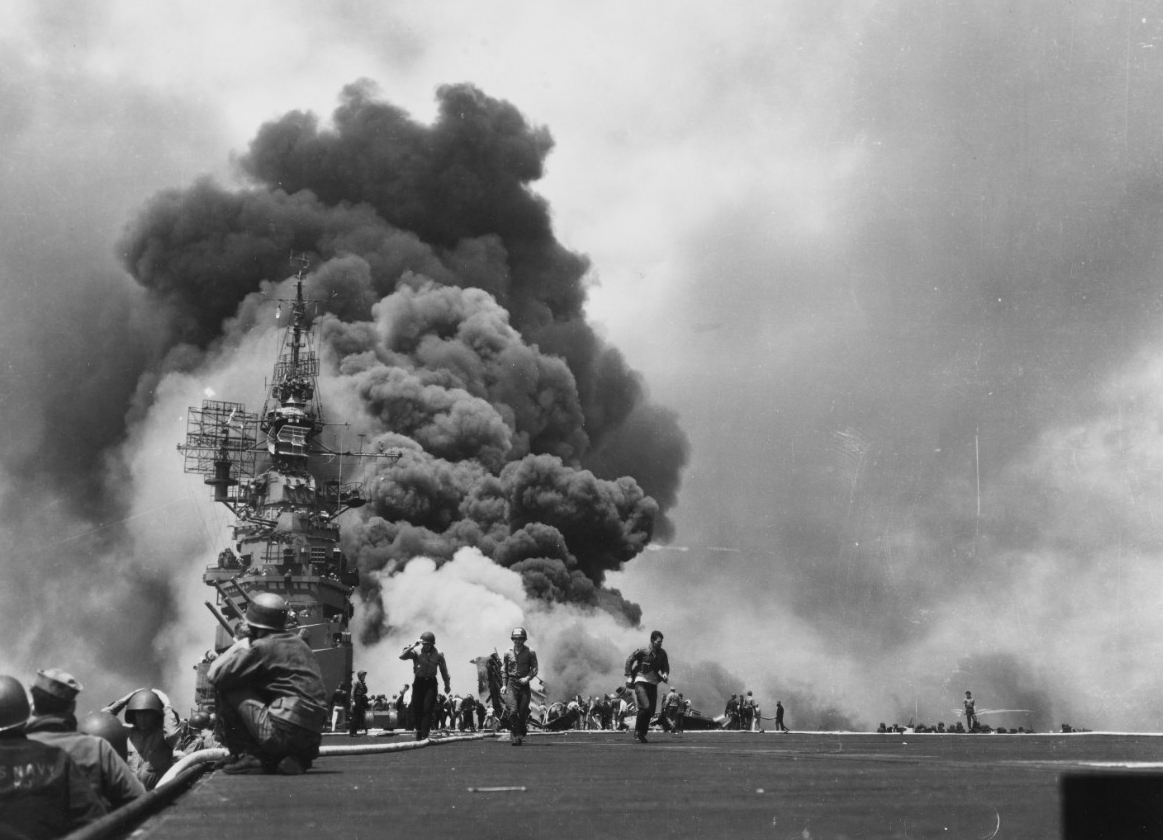 The scene on Bunker Hill’s flight deck looking aft, while her crew fights fires caused by the two kamikaze attacks off Okinawa on 11 May 1945. This iconic image from World War II appears on the RCA Victor recording of the orchestral suite Victory...