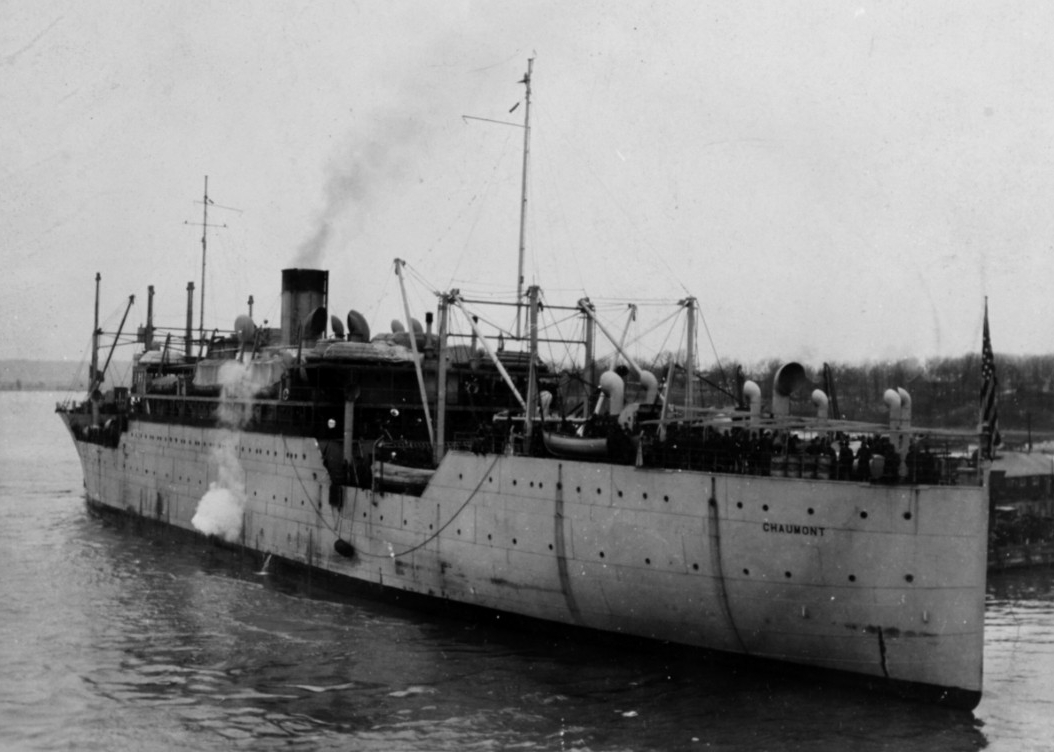 Chaumont moored to a landing with troops on deck in the 1920s or 1930s. (Naval History and Heritage Command Photograph NH 55090)
