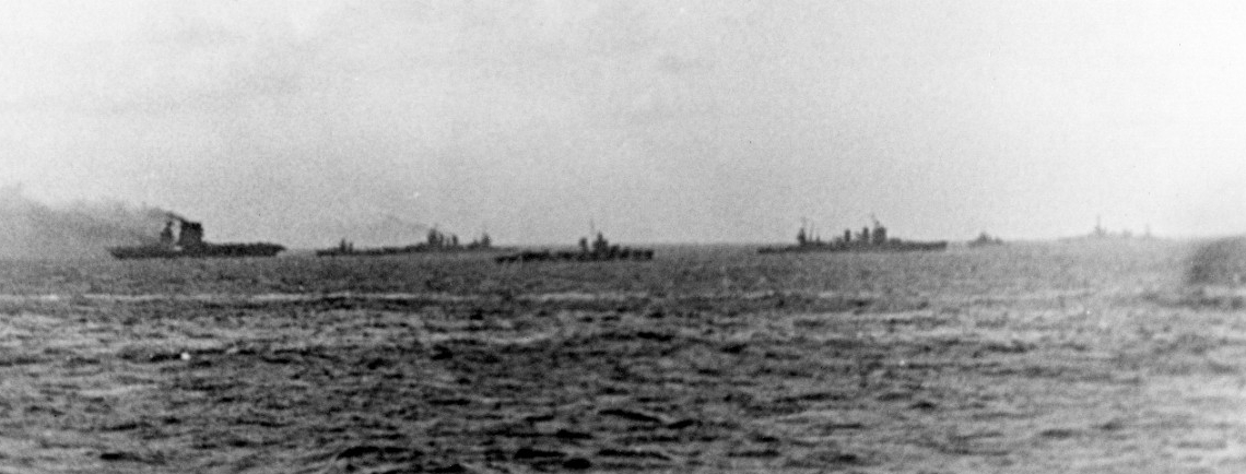 While Lexington burns at left, heavy cruisers and destroyers stand by; Chester is visible in the distance at right, 8 May 1942. (Naval History and Heritage Command Photograph NH 76562)