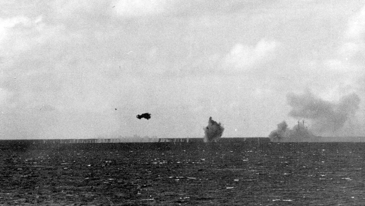 Engaged in a duel with Japanese shore batteries on Tinian Island on 24 July 1944, smoke again wreathes Cleveland as her main and secondary guns cycle to continuous fire (U.S. Navy Photograph 80--G--255389, National Archives and Records Administration, Still Pictures Branch, College Park, Md.)