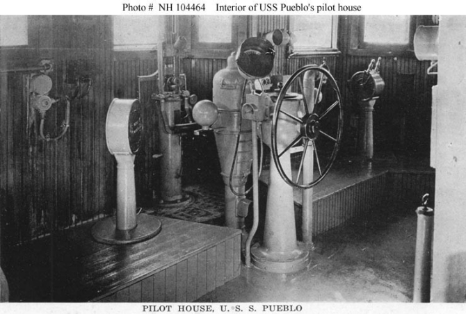 Halftone reproduction of a photograph of the interior of the ship’s pilot house, taken circa 1919. This was published in 1919 as one of ten images in a “Souvenir Folder” concerning Pueblo.