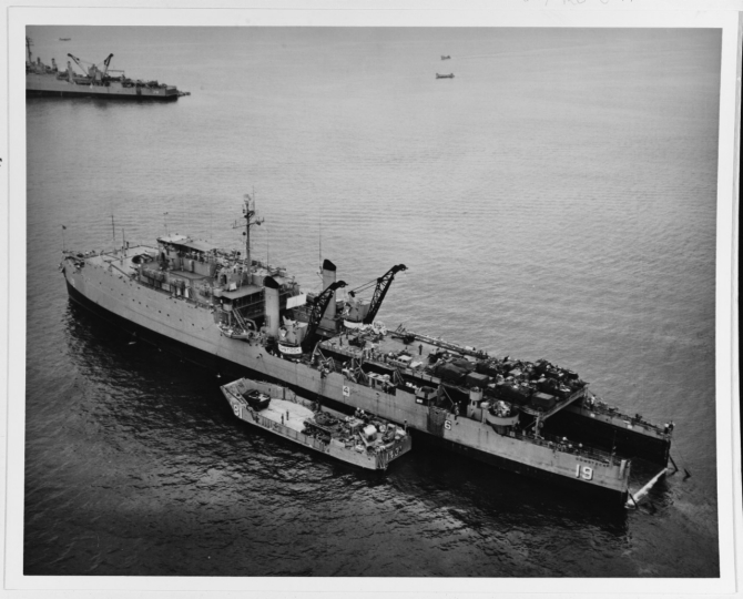 Comstock prepares to off load troops into landing craft at Chu Lai, South Vietnam in May 1965. (R.W. Smith, U.S. Navy Photograph, National Archives, USN 1111760).