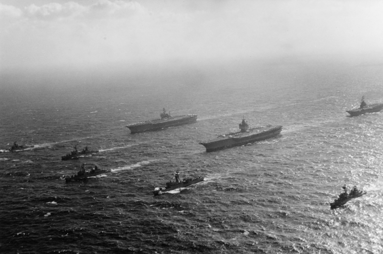 America, Enterprise, Oriskany, Ranger, Cone, Corry, William C. Lawe, Bronstein, and Fanning display a powerful array of naval might as they steam in the South China Sea, 28 January 1973. (Naval History and Heritage Command Photograph K-97942)