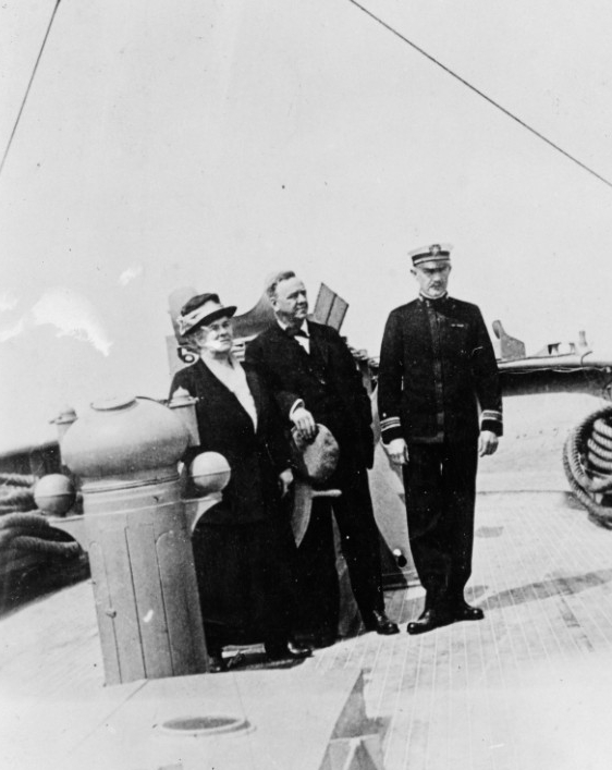 While at Plymouth, England, on 8 May 1919, Secretary of the Navy Josephus Daniels (center) with Mrs. Daniels, and Lt. Cmdr. William B. Porter, USNRF, the ship's commanding officer, pose for a photograph by Corsair's after conning station. (Naval History and Heritage Command Photograph NH 55392)