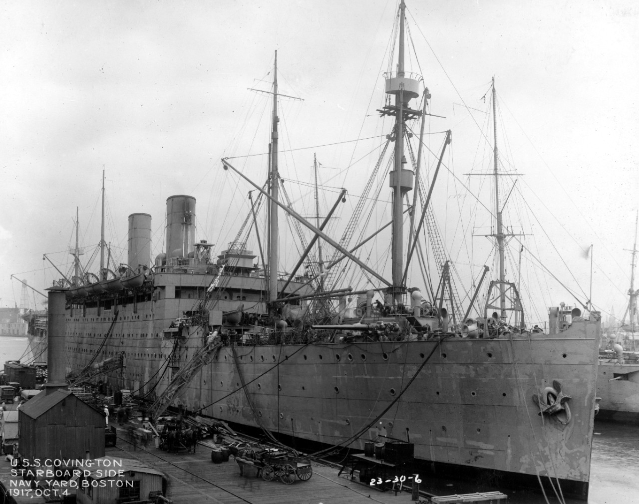 Covington moored at the Boston Navy Yard, 4 October 1917, her starboard forward 6-inch gun trained almost on the beam. Note dockside activity, with horse-drawn transport and a Lehigh Valley railroad box car in evidence on the pier. (U.S. Navy Bureau of Ships Photograph 19-N-3402, National Archives and Records Administration, Still Pictures Division, College Park, Md.)