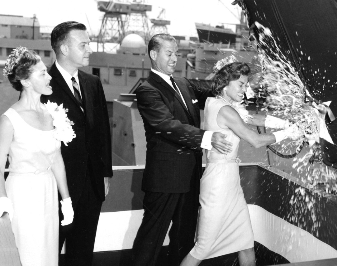 Mrs. Betty Ford christens Dace at Pascagoula, 18 August 1962. Looking on are (left to right) Mrs. Thomas G. Ford, matron of honor; the Honorable Kenneth E. BeLieu, Assistant Secretary of the Navy; and Mr. Fred J. Mayo, President of Ingalls Shipbuilding. (Dace (SSN-607), Ships History Files, Naval History and Heritage Command)