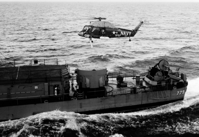 Aircraft 08, a Kaman UH-2A Seasprite of Helicopter Utility Squadron (HU) 2 (BuNo. 149757), flying from Franklin D. Roosevelt (CVA-42), hoists a crewman aloft from Douglas H. Fox in the Atlantic, 12 August 1964. Note the variable depth sonar on the ship’s fantail. (Unattributed U.S. Navy Photograph USN 1107341, Photographic Section, Naval History and Heritage Command)
