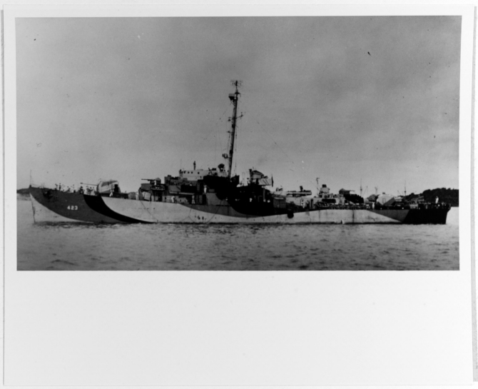 A port broadside view of the anchored ship captures her in wartime disruptive paint scheme, circa 1944. (U.S. Navy Photograph NH 79838, donated by D.M. McPherson in 1974, Photographic Section, Naval Heritage and History Command)