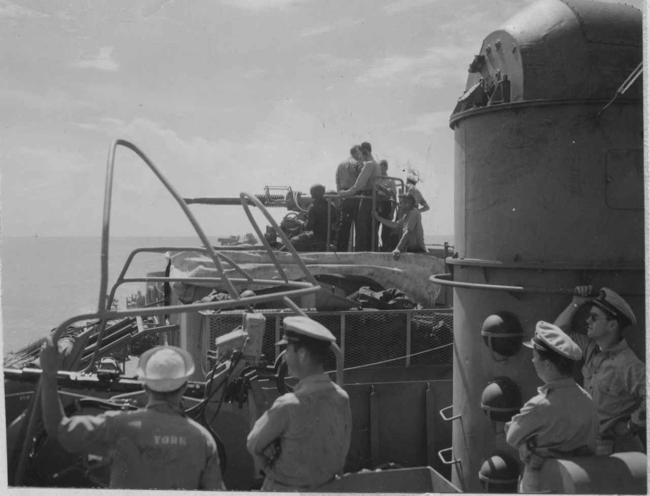 Edgar G. Chase conducts 40-millimeter gunnery practice, circa July 1944, the Bofors mount trained on the beam to starboard. Note racks for helmets on the supporting structure for the gun director (R), and some of the onlookers wearing cotton in t...