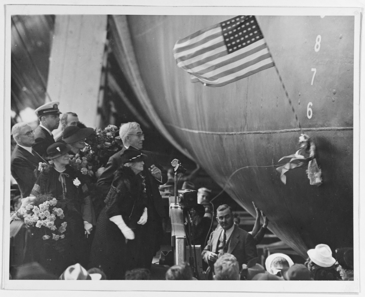 Mrs. Lulie H. Swanson, Enterprise sponsor, christens the ship at Newport News Shipbuilding & Drydock Co., 3 October 1936. (Naval History and Heritage Command Photograph NH 54223)