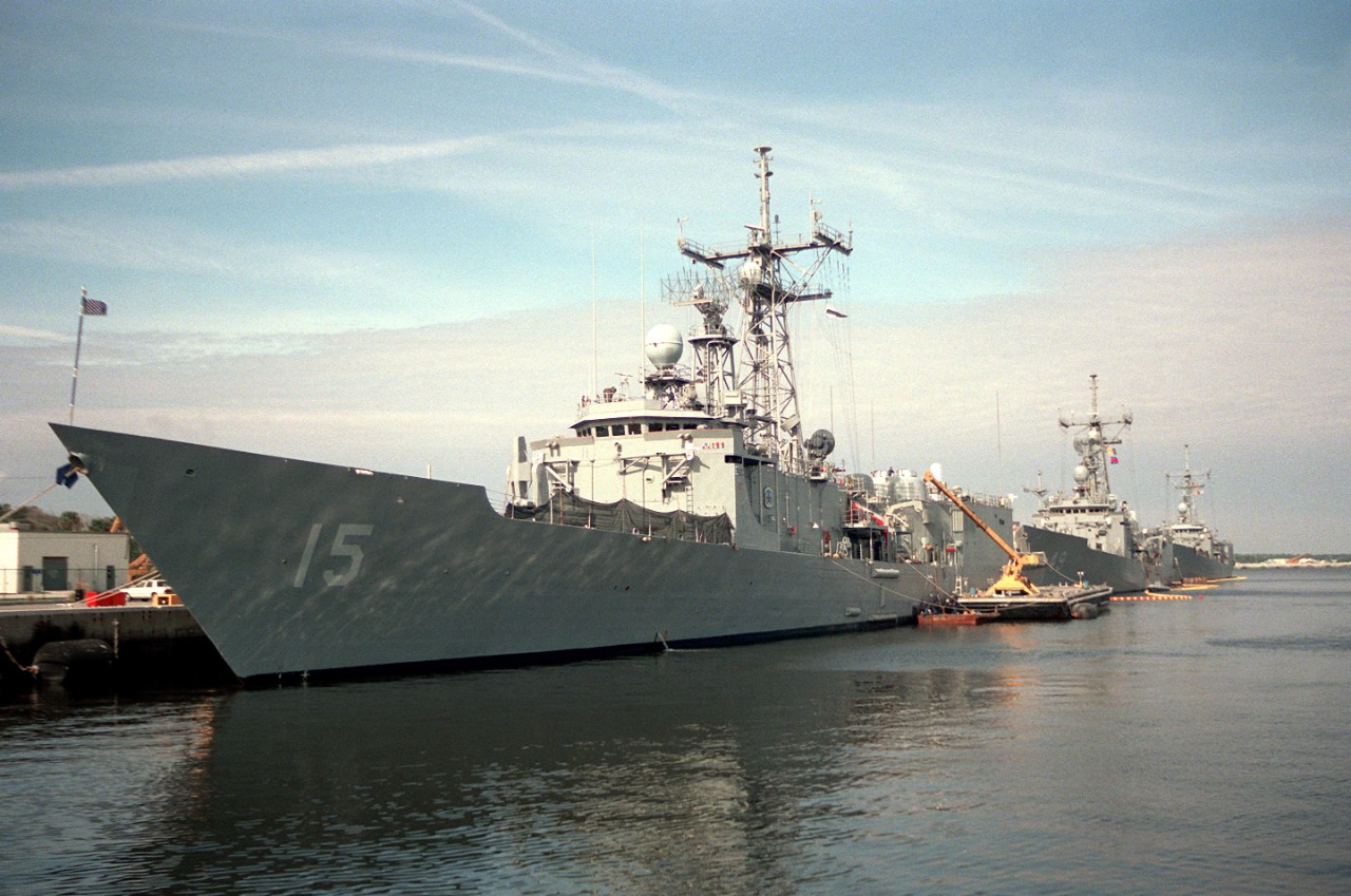 Estocin ties up at Mayport. Robert G. Bradley (FFG-49) and another Oliver Hazard Perry-class guided missile frigate lie moored astern of her. 5 February 1994. (U.S. Navy Photograph DN-SC-94-02382, OS2 John Bouvia, National Archives and Records Ad...