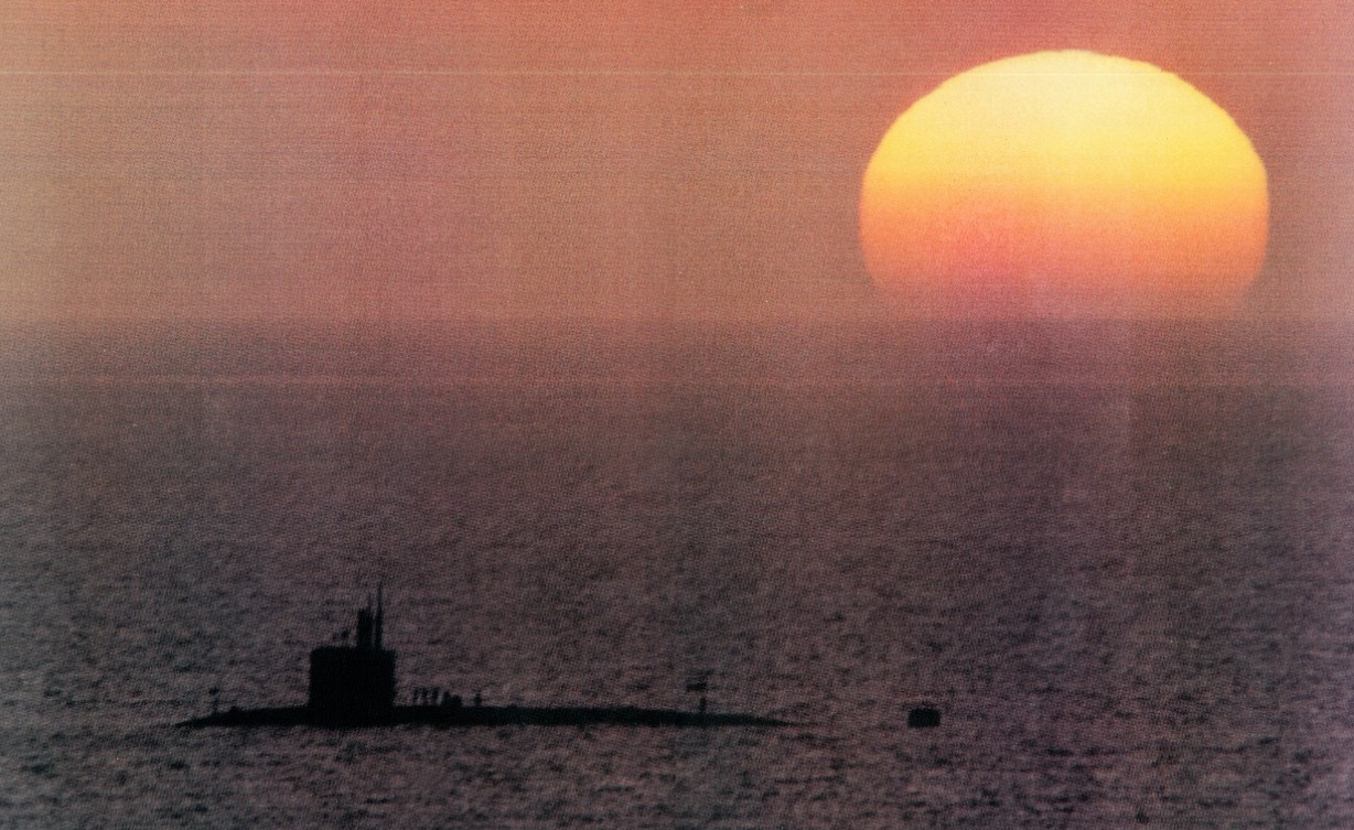 The sun sets on Finback during her anchorage at Puerto La Cruz (Finback Inactivation Booklet, NHHC Archives)