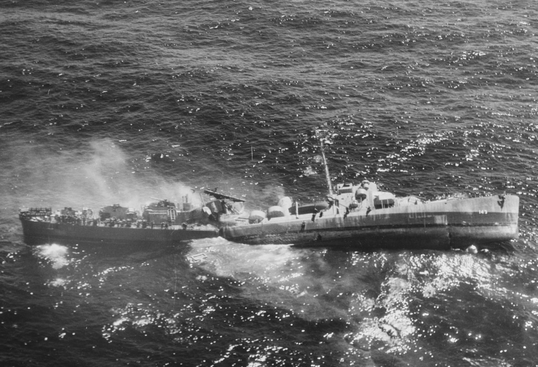 Fiske broken in two and sinking in the Atlantic Ocean on 2 August 1944, after she was torpedoed by the German submarine U-804. Note men abandoning ship by walking down the side of her capsized bow section. (U.S. Navy Photograph 80-G-270257, National Archives and Records Administration, Still Pictures Division, College Park, Md.)